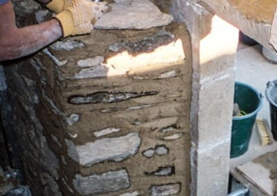 France Fortified Farm House: Traditional stone wall being build